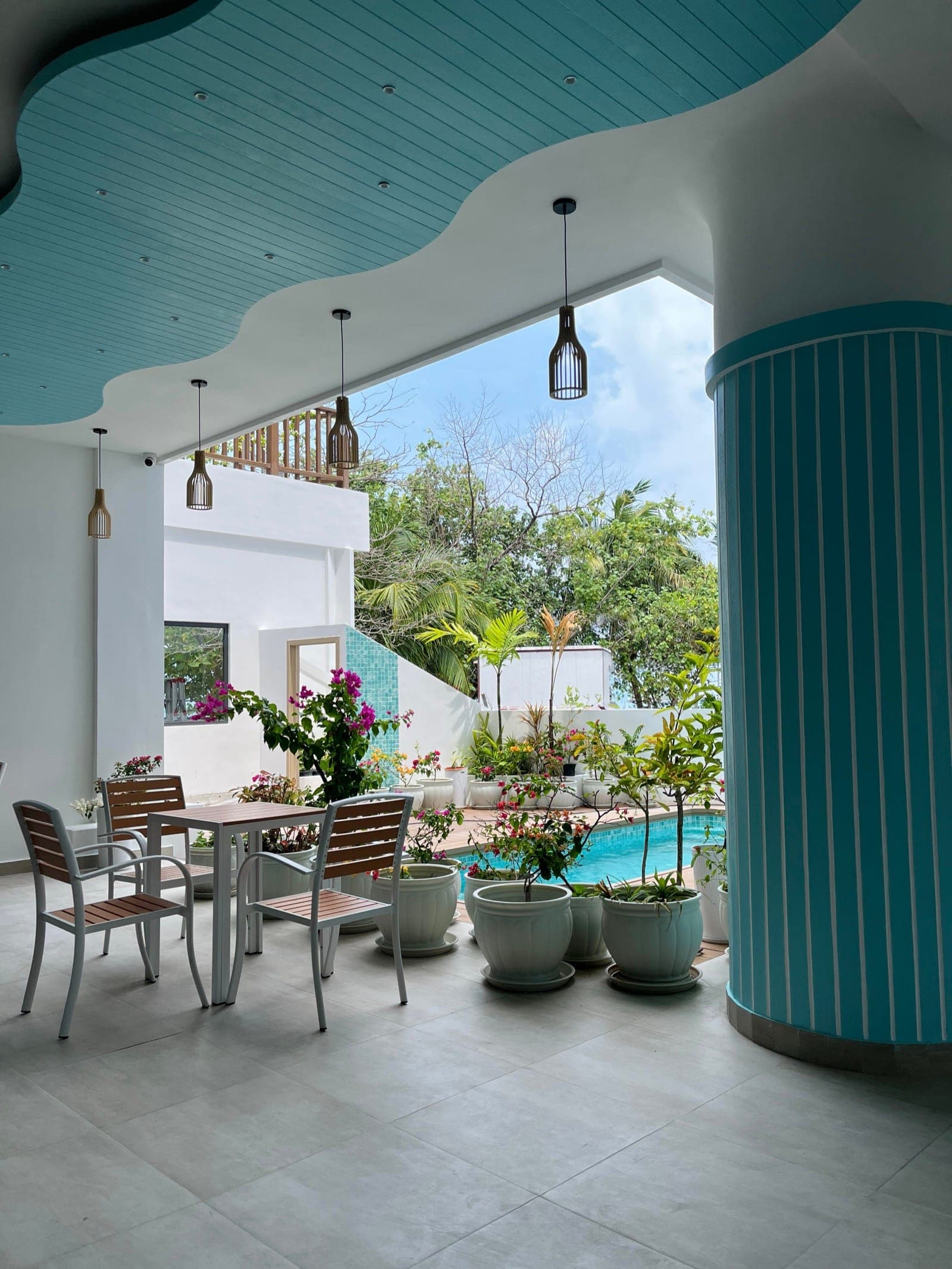 Poolside seating with turquoise cushions